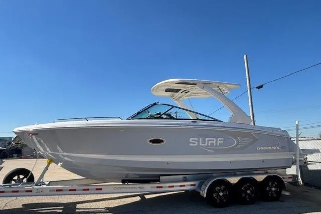Slide: The Image of 2024 Chaparral 30 Surf boat on trailer under clear blue sky. - 13