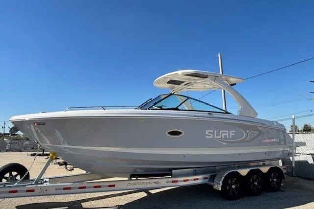 Slide: The Image of 2024 Chaparral 30 Surf boat on trailer under clear blue sky. - 14