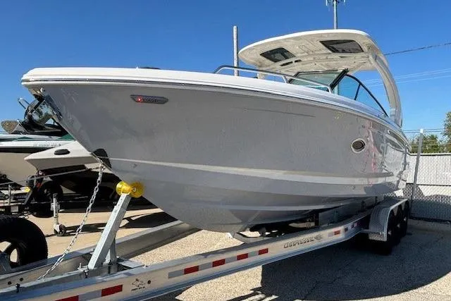 Slide: The Image of 2024 Chaparral 30 Surf boat on trailer under clear blue sky. - 15