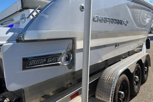 Slide: The Image of 2024 Chaparral 30 Surf boat on trailer, sleek design, ready for adventure. - 17