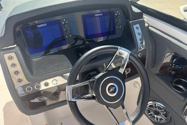 Slide: The Image of 2024 Chaparral 30 Surf boat on trailer under blue sky. - 2