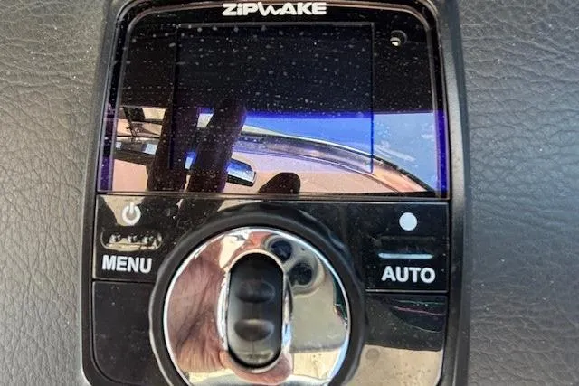 Slide: The Image of 2024 Chaparral 30 Surf boat interior seating, featuring sleek white and gray upholstery. - 22