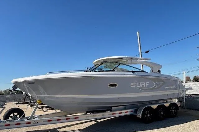 Slide: The Image of 2024 Chaparral 30 Surf boat interior with sleek white seating and modern dashboard. - 31