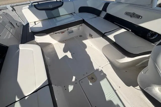 Slide: The Image of 2024 Chaparral 30 Surf boat on a trailer, displayed outdoors under clear blue sky. - 32