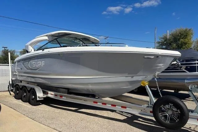 Slide: The Image of Trailer with spare tire for 2024 Chaparral 30 Surf boat, parked on pavement. - 42