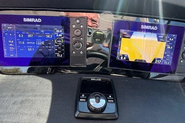 Slide: The Image of 2024 Chaparral 30 Surf boat interior with white seating and sun lounge area. - 9