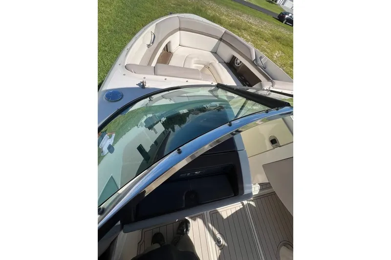 Slide: The Image of 2012 Sea Ray 250 SLX boat interior with beige seating and windshield. - 10