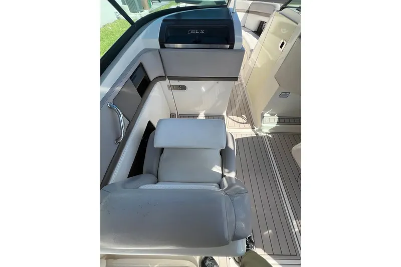 Slide: The Image of 2012 Sea Ray 250 SLX boat interior with seating and dashboard. - 7