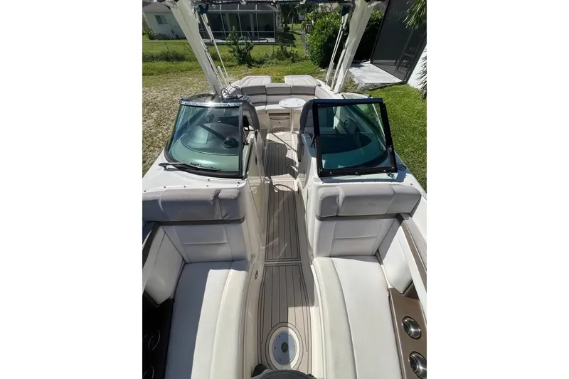 Slide: The Image of 2012 Sea Ray 250 SLX boat interior with white seating and open deck layout. - 9
