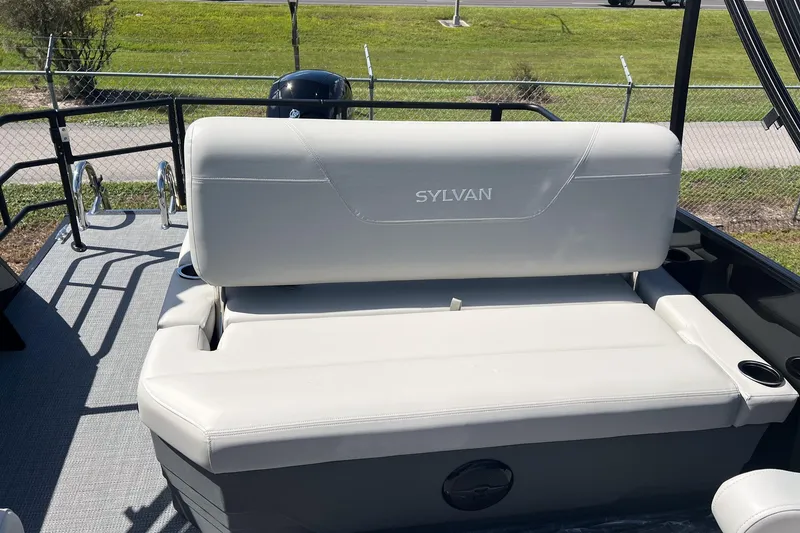 Slide: The Image of 2026 Sylvan MIRAGE 822 CLZ DH boat with white seating and outdoor view. - 10
