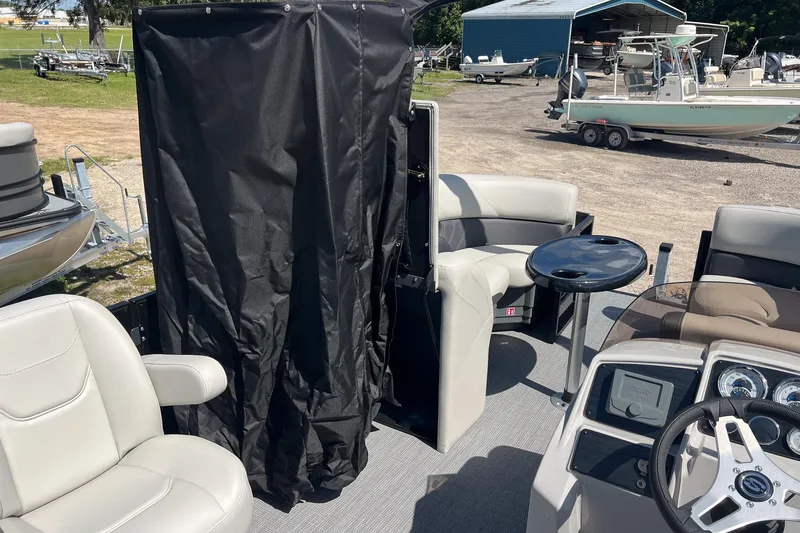 Slide: The Image of 2026 Sylvan MIRAGE 822 CLZ DH boat interior with seating and steering console. - 12