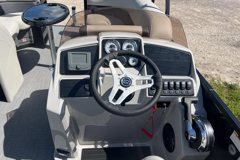 Slide: The Image of 2026 Sylvan MIRAGE 822 CLZ DH boat dashboard with steering wheel and controls. - 13