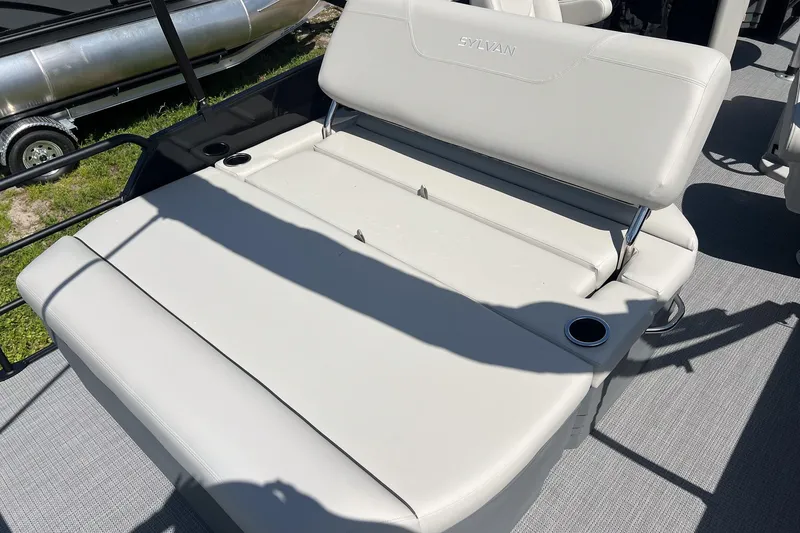 Slide: The Image of 2026 Sylvan MIRAGE 822 CLZ DH boat interior with cushioned seating and cup holders. - 17