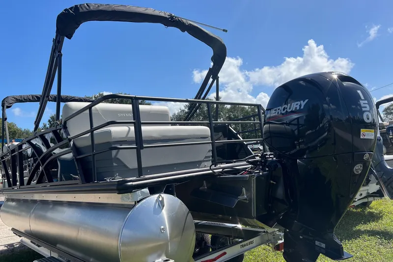 Slide: The Image of 2026 Sylvan MIRAGE 822 CLZ DH pontoon boat with Mercury 150 engine, parked outdoors. - 2