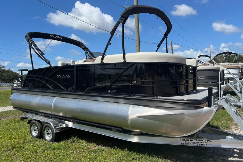 Slide: The Image of 2026 Sylvan MIRAGE 822 CLZ DH pontoon boat on trailer, under clear blue sky. - 4