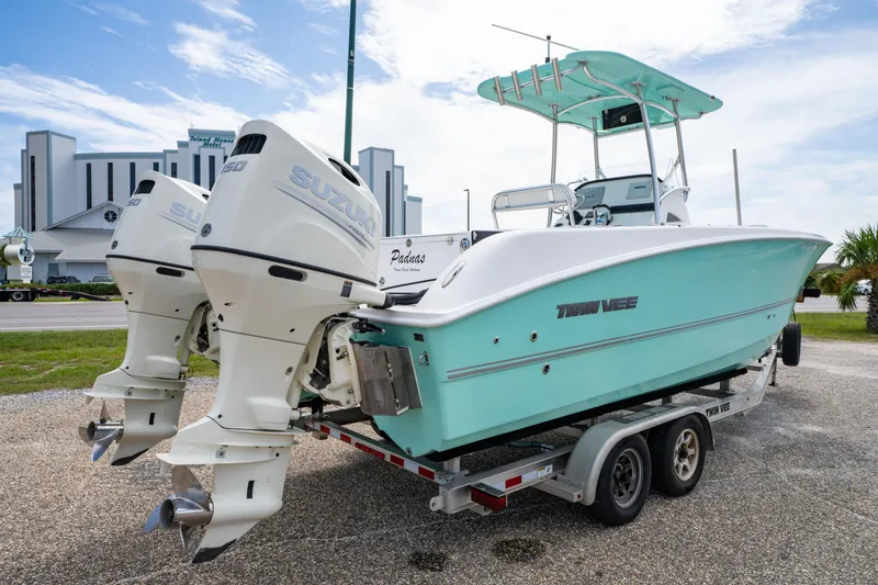 Slide: The Image of 2019 Twin Vee 240 GFX CC boat with dual Suzuki engines on a trailer. - 10