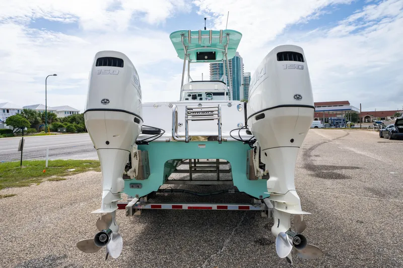 Slide: The Image of 2019 Twin Vee 240 GFX CC boat with dual Suzuki outboard motors on a trailer. - 12