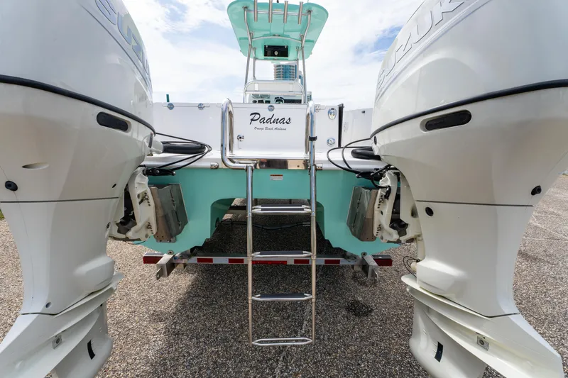 Slide: The Image of 2019 Twin Vee 240 GFX CC boat with dual Suzuki engines and ladder. - 13