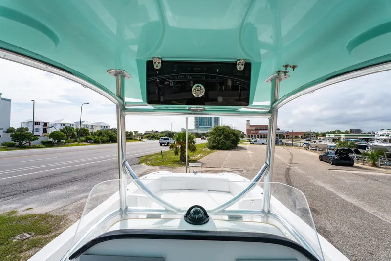 Slide: The Image of 2019 Twin Vee 240 GFX CC boat interior view with road and buildings in background. - 17
