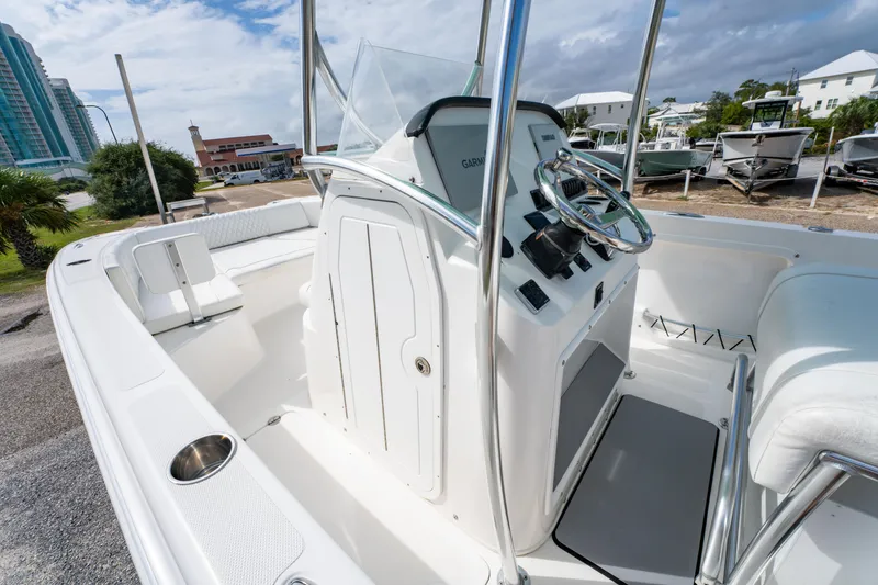 Slide: The Image of 2019 Twin Vee 240 GFX CC boat interior with steering console and seating. - 22