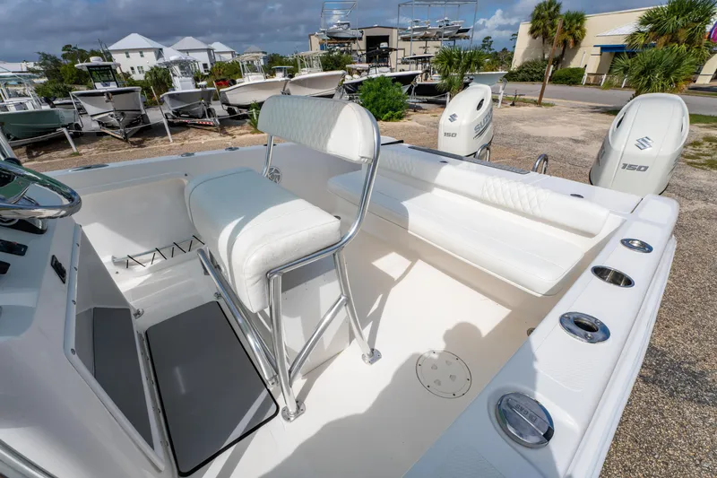 Slide: The Image of 2019 Twin Vee 240 GFX CC boat interior with seating and dual Suzuki 150 engines. - 23