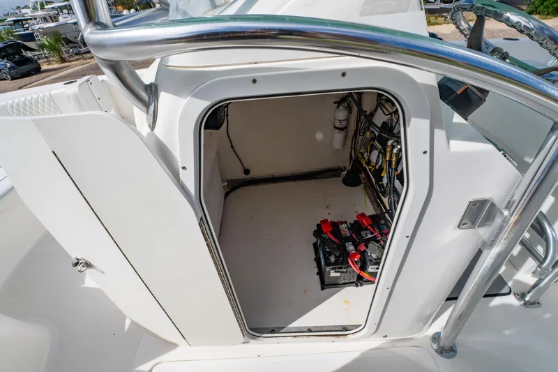 Slide: The Image of 2019 Twin Vee 240 GFX CC boat storage compartment with batteries and wiring. - 25