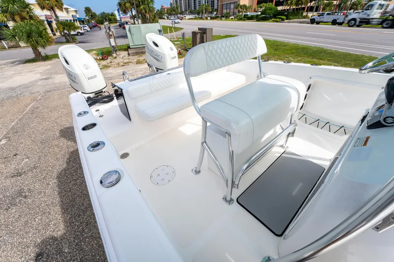 Slide: The Image of 2019 Twin Vee 240 GFX CC boat interior with seating and dual Suzuki engines. - 26