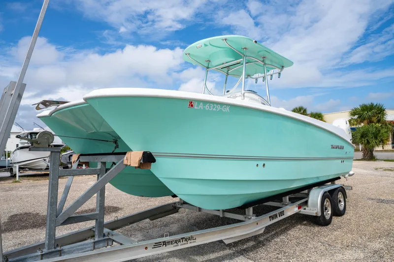 Slide: The Image of 2019 Twin Vee 240 GFX CC boat on trailer under blue sky. - 3