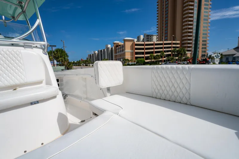 Slide: The Image of 2019 Twin Vee 240 GFX CC boat interior with white seating, cityscape background. - 33