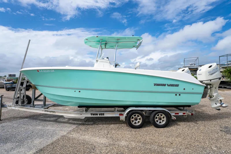 Slide: The Image of 2019 Twin Vee 240 GFX CC boat on trailer under blue sky. - 4