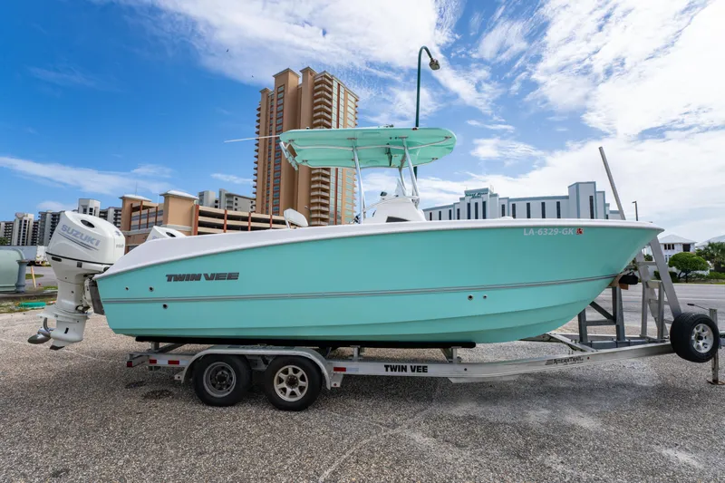 Slide: The Image of 2019 Twin Vee 240 GFX CC boat on trailer, cityscape background. - 7