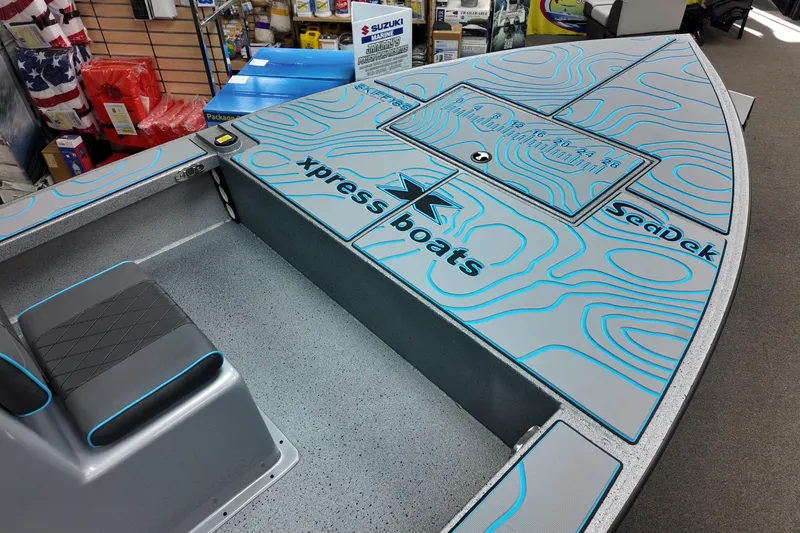 Slide: The Image of 2026 Xpress Skiff 185 boat interior with SeaDek flooring and storage compartments. - 10