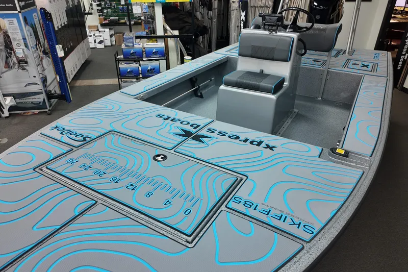 Slide: The Image of 2026 Xpress Skiff 185 boat interior with seating and measurement markings. - 13