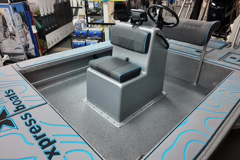 Slide: The Image of 2026 Xpress Skiff 185 boat interior with modern seating and steering console. - 14