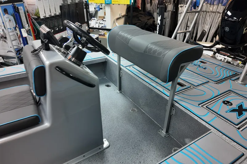 Slide: The Image of 2026 Xpress Skiff 185 interior with modern seating and steering console. - 15