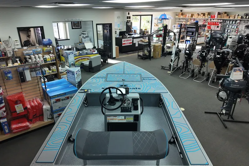 Slide: The Image of 2026 Xpress Skiff 185 displayed in a marine equipment store with various boating accessories. - 17