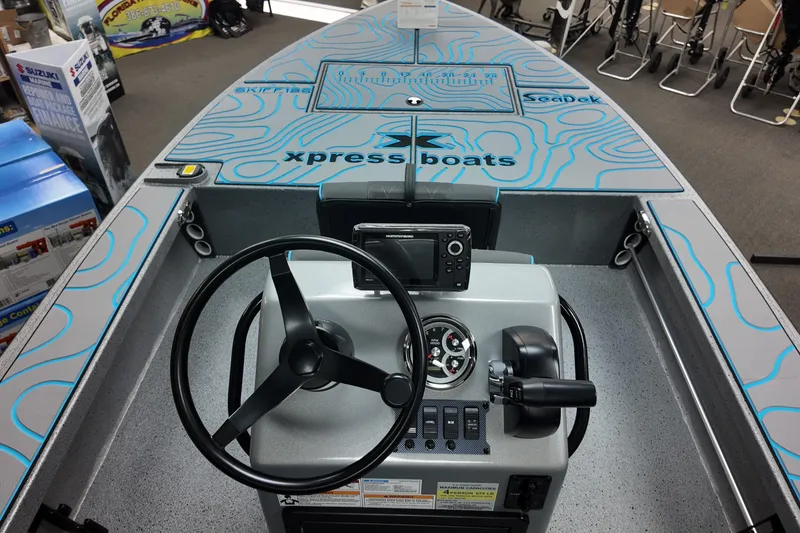 Slide: The Image of 2026 Xpress Skiff 185 boat interior with steering wheel and control panel. - 18