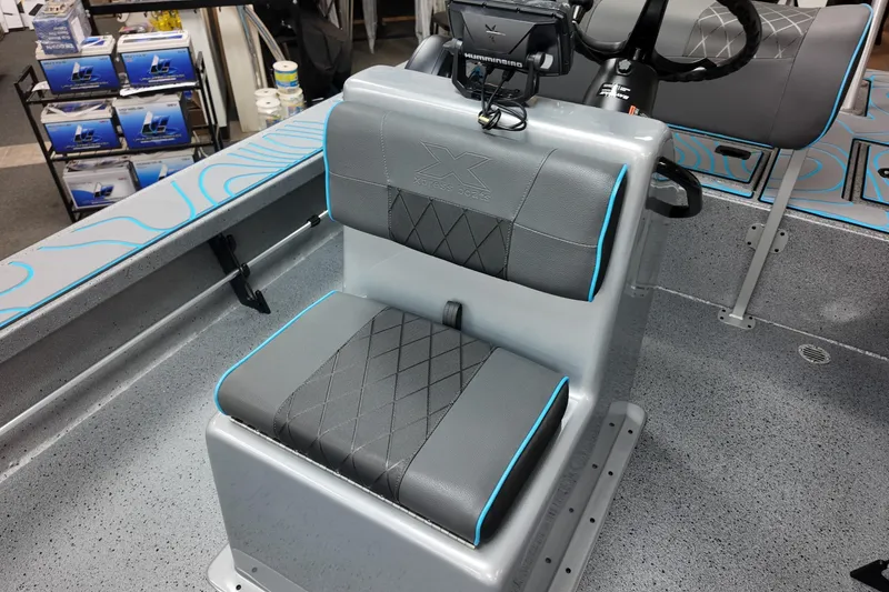 Slide: The Image of 2026 Xpress Skiff 185 boat interior with gray seating and blue accents. - 22