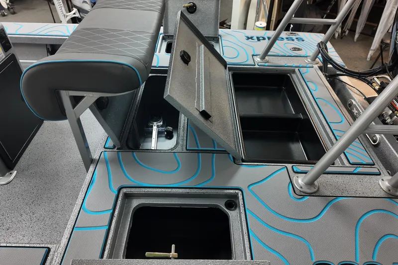 Slide: The Image of 2026 Xpress Skiff 185 interior with open storage compartments and seating. - 24