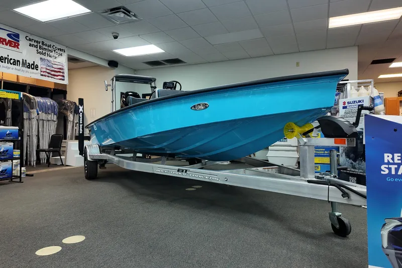 Slide: The Image of 2026 Xpress Skiff 185 boat displayed indoors on a trailer. - 3