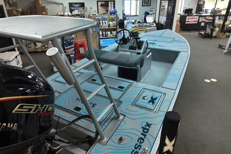 Slide: The Image of 2026 Xpress Skiff 185 boat with Yamaha engine in showroom display. - 7