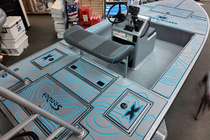 Slide: The Image of 2026 Xpress Skiff 185 boat interior with custom blue and gray deck design. - 8