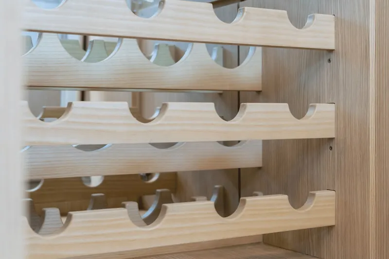 Slide: The Image of An elegant wine rack made of light wood with multiple shelves. - 49
