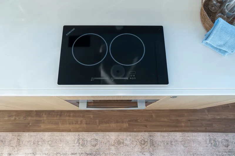 Slide: The Image of Modern kitchen with induction cooktop and wooden flooring on the 2027 Aquila A42Y. - 44