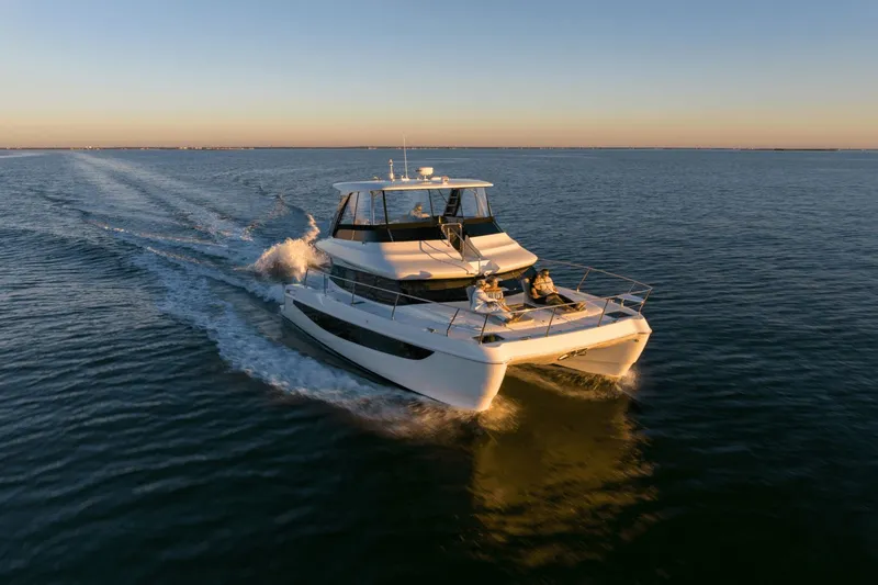 Slide: The Image of The 2027 Aquila A42Y cruising on calm waters at sunset. - 1