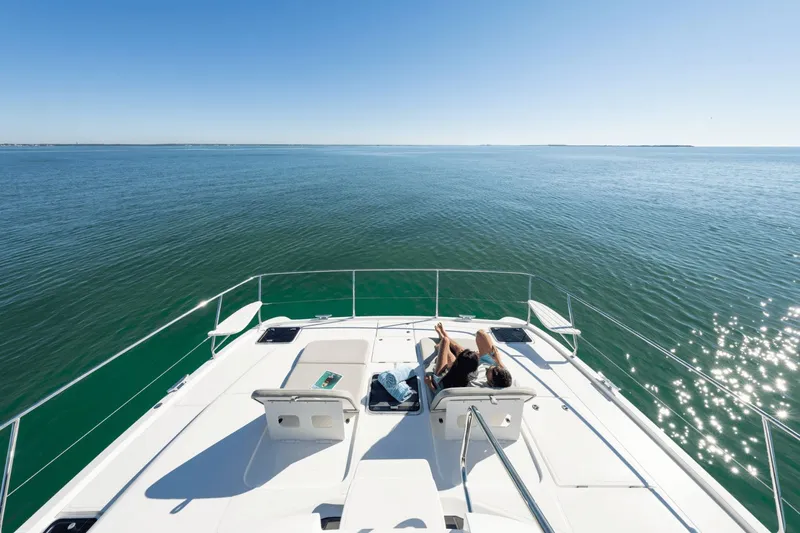 Slide: The Image of Person relaxing on the deck of a 2027 Aquila A42Y, overlooking the open sea. - 24