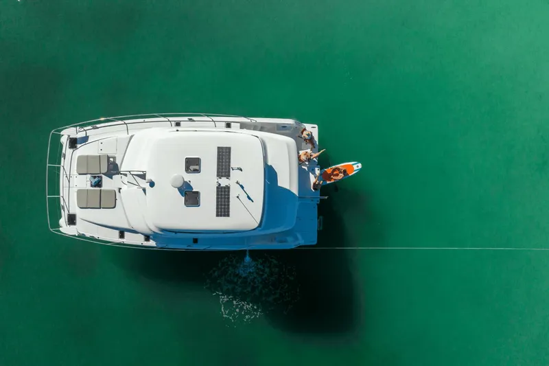 Slide: The Image of Aerial view of a 2027 Aquila A42Y on calm, green water with people on board. - 8