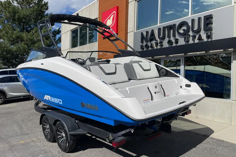 Slide: The Image of 2025 Yamaha AR250 boat on trailer outside Nautique dealership in Utah. - 3