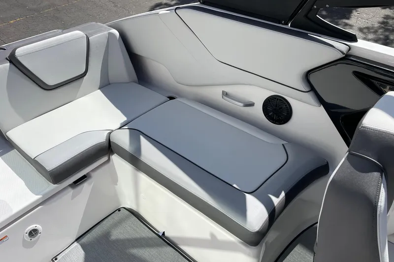 Slide: The Image of 2025 Yamaha Boats AR250 interior seating with sleek design and integrated speaker system. - 9