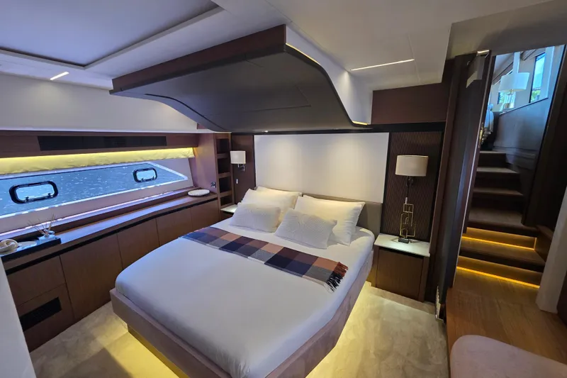 Slide: The Image of Luxurious bedroom interior of 2022 Prestige X70 yacht, featuring modern design and ambient lighting. - 10